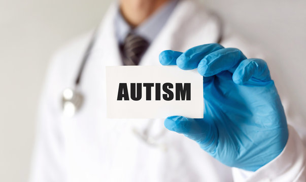 Doctor holding a card with text Autism, Medical concept