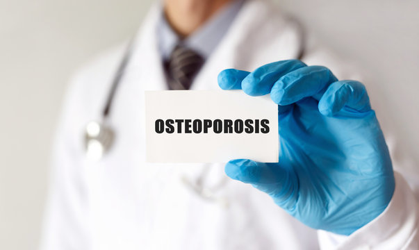 Doctor Holding A Card With Text Osteoporosis, Medical Concept