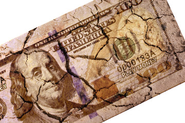 Cracked US paper dollar currency on isolated white background