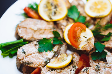 Baked salmon fish fillet with tomatoes, mushrooms and spices. Diet menu, closeup