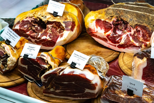 Parma ham and speck displayed for sale