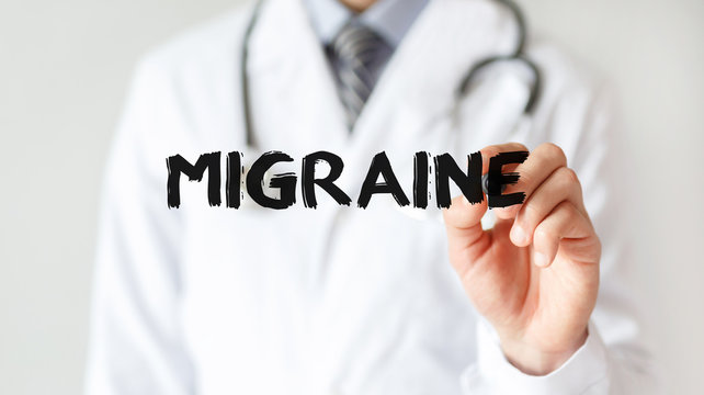 Doctor writing word Migraine with marker, Medical concept