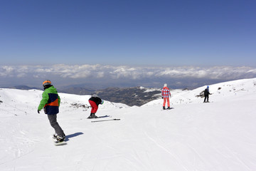 On the snow-capped peaks of  the mountain Sierra Nevada skiers and snowboarders