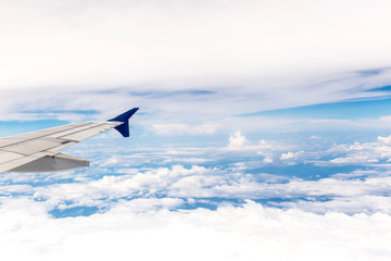 Looking through window aircraft during flight in wing with a blue sky