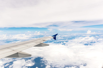Looking through window aircraft during flight in wing with a blue sky