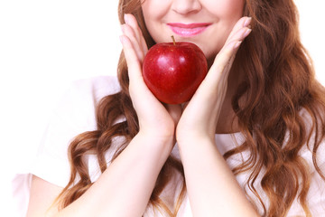 Woman holding apple fruit close to face