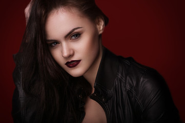 Fototapeta premium studio portrait beauty young girl on red background 