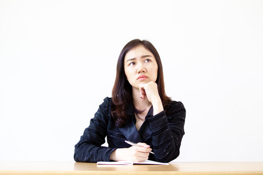 Asian business women age between 25-30 years old in the black suit in action close up on white background.  Concept of thinkful and idea generation.