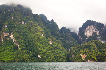 Beautiful landscape of mountain and lake while raining, the mountain was covered by low level rain...