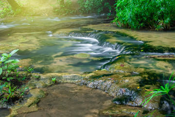 Beautiful small waterfall in the deep forest in Thailand.