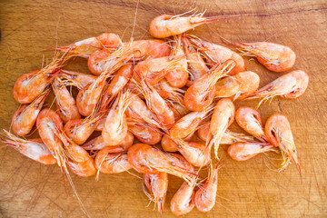 boiled red shrimps on wooden tray