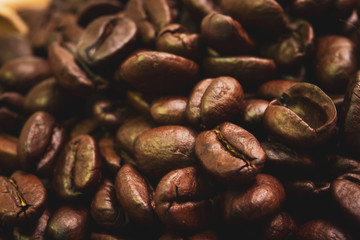 Medium roasted organic coffee beans close up.  Processed in vintage and worm tone color.