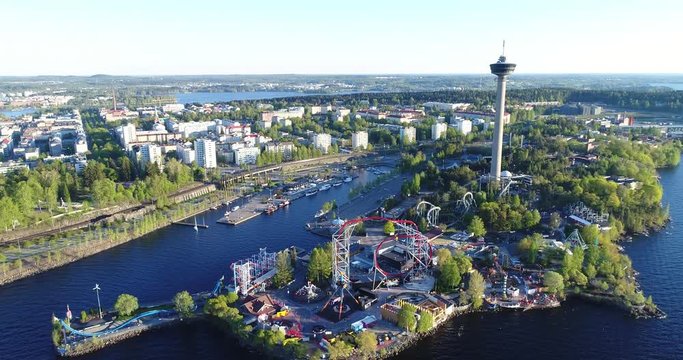 Beautiful aerial footage of amusement park
in Tampere city at summer. Camera moves forward.