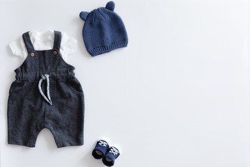 View from above of fashion trendy stuff on white background for newborn baby boy, flat lay.