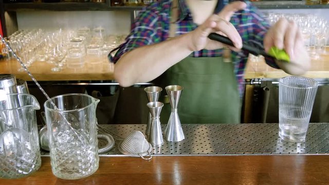 Caipirinha cocktail. The barman preparing an alcoholic drink in a bar. 4K