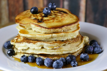 Stack of Blueberry Pancakes with Maple Syrup and Fresh Blueberries