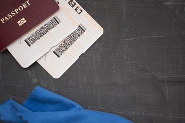 passport and tickets on a concrete background, top view