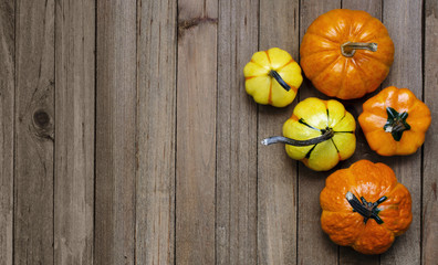 Orange and Yellow Fall Gourds on a Wooden Background