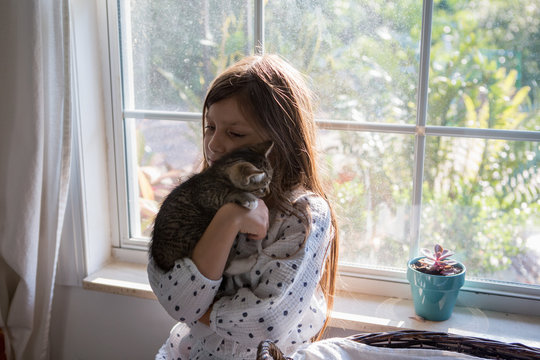 A girl holding kittens.