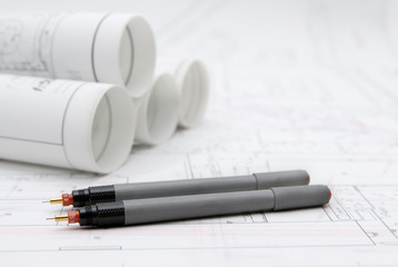 Rolled-up architectural plans and drawing tools