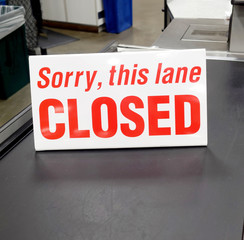 Red and white grocery store checkout lane sign: SORRY, THIS LANE CLOSED.