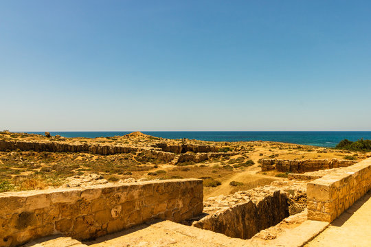 Ruins and columns of the ancient city of Paphos, Cyprus. Mediterranean Sea in the background. 