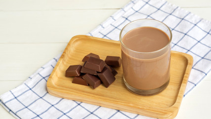 Chocolate milk on a white wooden table.