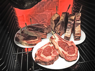 dry ageing ribeye steaks with extra long rib bones