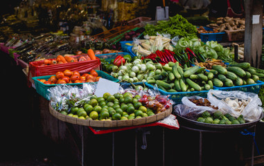exotic fruits and vegetables on the shelves of market, Asia