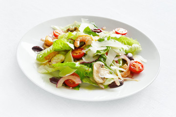 romaine salad with scampi, champingons, tomatoes, olives, and onion dressed with modena vinegar and olive oil and sprinkled with parmesan