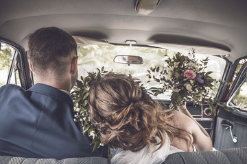Wife with husband driving vintage car happy together copy space banner
