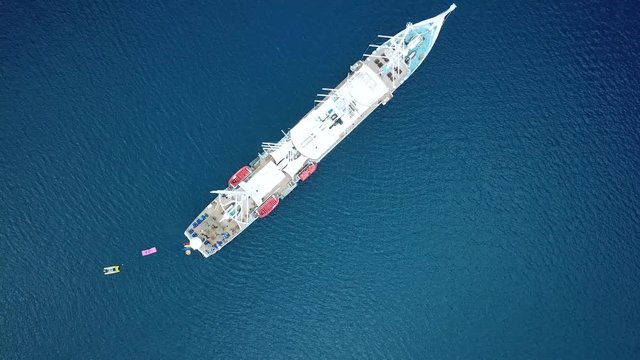 Aerial footage from a drone of a luxury cruise ship at Bora Bora island, Tahiti, French Polynesia, South Pacific Ocean (Bora Bora Aerial)
