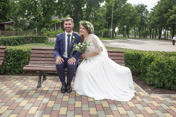 Bride and husband wedding happy together sitting near the railway station copy space banner 