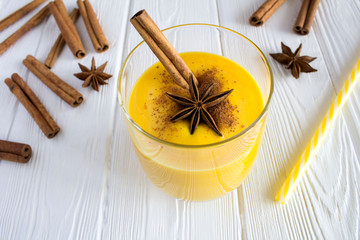 Milk smoothies with pumpkin,cinnamon and anise  on the white wooden background.Closeup.