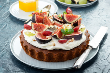 Delicious creamy tart cake with fresh figs and grape.