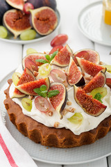 Delicious creamy tart cake with fresh figs and grape.
