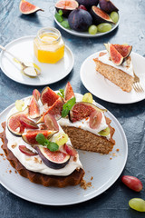 Delicious creamy tart cake with fresh figs and grape.