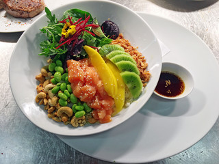 diced raw fish with fruits, nuts, vegetables and rice