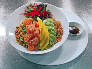 diced raw fish with fruits, nuts, vegetables and rice 