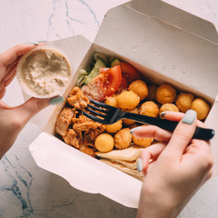 open gyros with chicken, potato balls, pita and vegetables