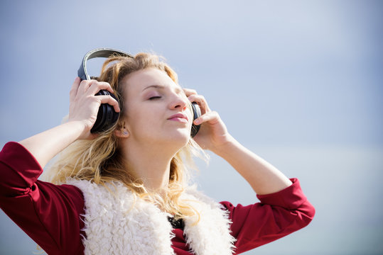 Woman wearing headphones outdoor