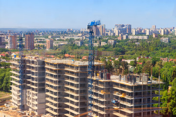 Naklejka premium Building crane and house under construction