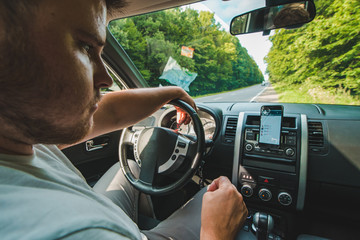 man check navigation on mobile in car