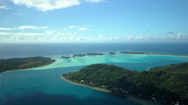 Aerial footage from a drone of blue lagoon and small islands at Bora Bora island, Tahiti, French Polynesia , South Pacific Ocean (Bora Bora Aerial)
