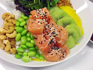 diced raw fish with fruits, nuts, vegetables and rice 