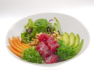 diced raw fish with fruits, nuts, vegetables and rice 