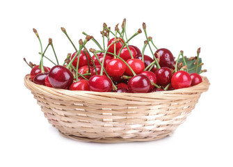 Ripe red fresh cherry in a wicker basket on a white isolated background