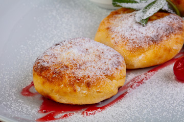 Delicious syrniki with cream