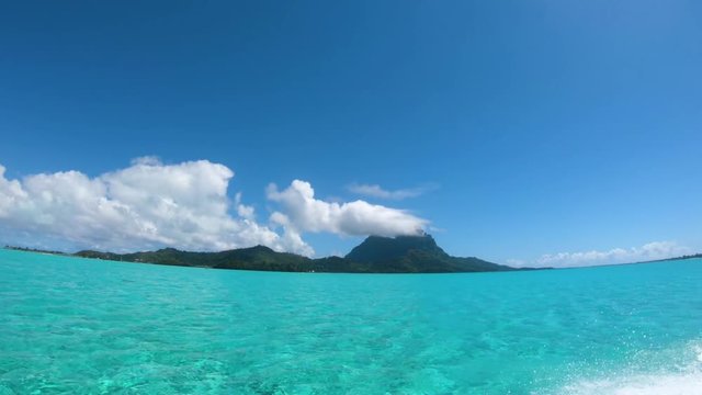 Sailing around blue lagoon and Otemanu mountain at Bora Bora island, Tahiti, French Polynesia (view from action camera)
