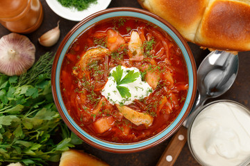Russian red soup borscht with sour-cream and parsley.
